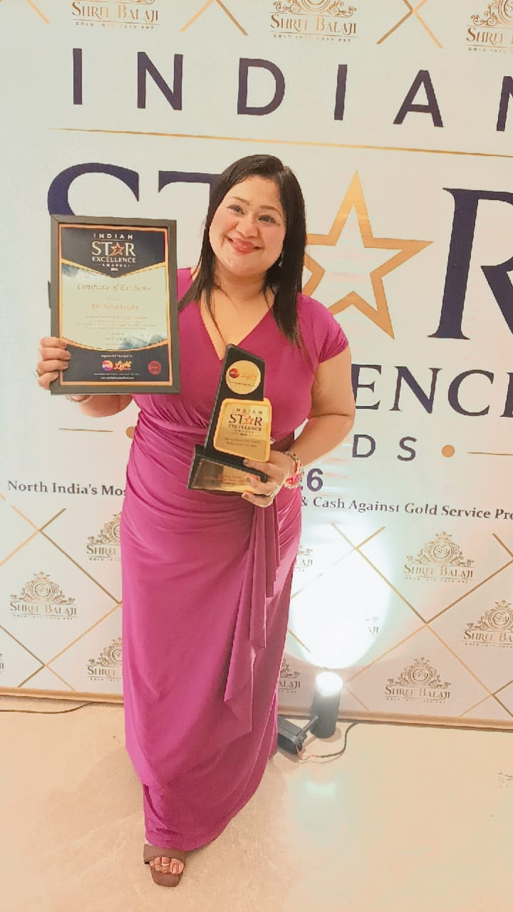 Dr. Neha Gupta holding the Certificate of Excellence and Indian Star Excellence Trophy